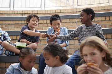 Photo of kids eating sweets and healthy snacks